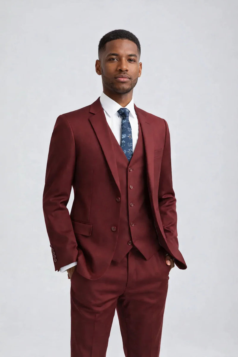 Man wearing a Men's Burgundy Slim Fit Suit three-pieces with white shirt and floral tie, formal attire